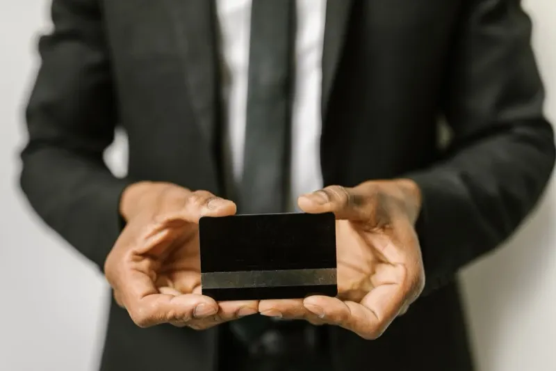 Carte de paiement professionnelle tenue en main, fonctionnalité de cartes physiques et virtuelles d'un logiciel de gestion des dépenses